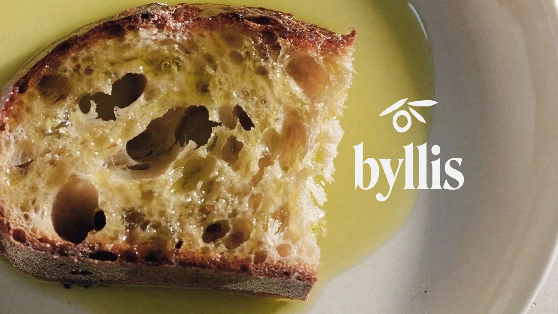Bread dipped in olive oil with the Byllis logo
