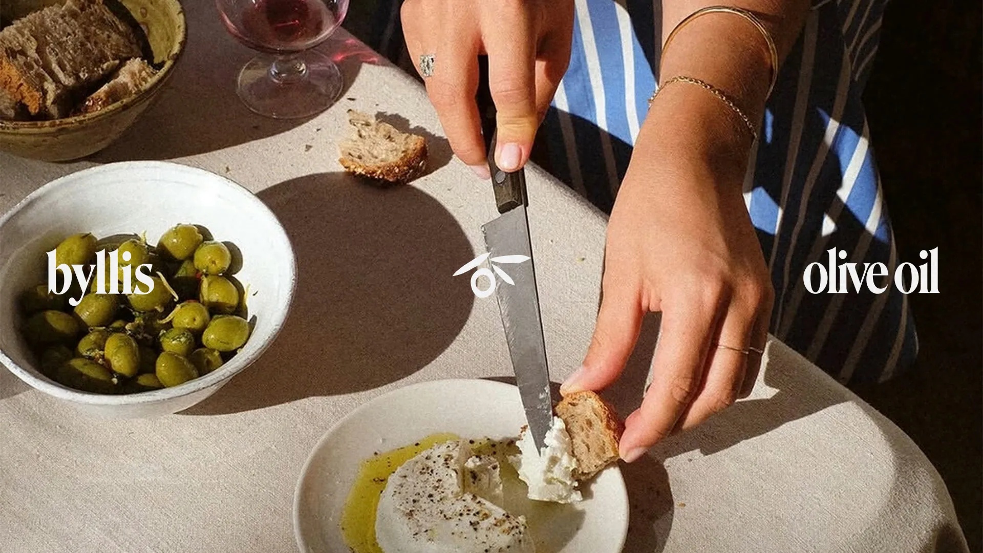 Table with olives and bread: byllis olive oil