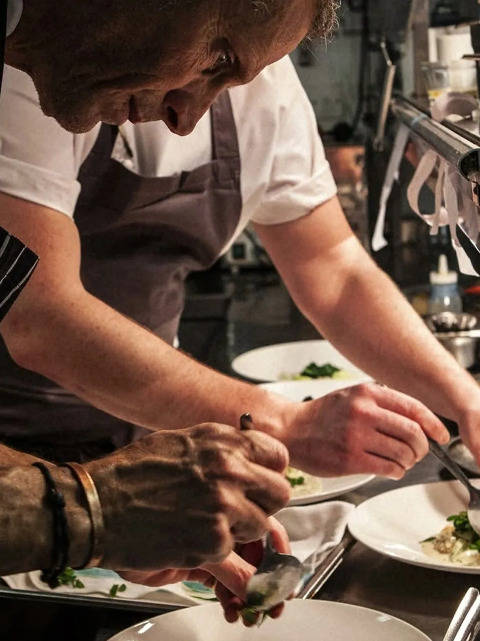 Chef finishing plates in the kitchen