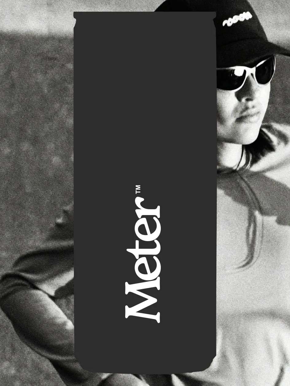 Runner in black and white holding a Meter can